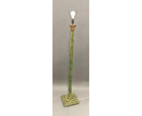 A decorative green painted standard lamp