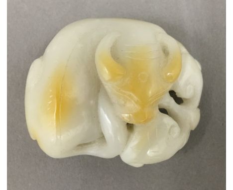 A white jade carving of a bull
