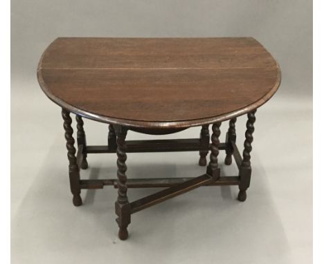 An early 20th century oak barley twist gate leg table