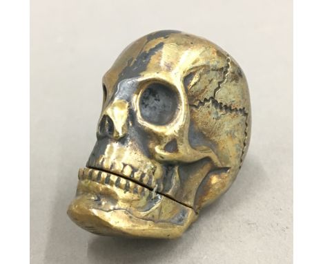A brass vesta in the form of a skull