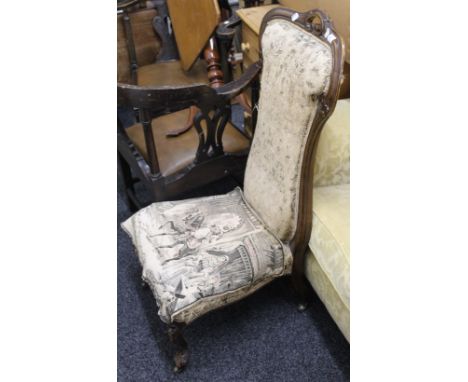 A Victorian walnut framed tapestry covered nursing chair