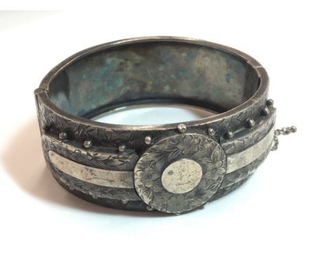 A Victorian silver hinged cuff bangle (35 grammes total weight)