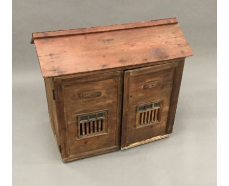 A 19th century pine animal hutchOf architectural form, with hinged lid and twin pierced and glazed doors.  86.5 cm wide; 77 c