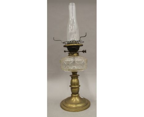 A Victorian brass and cut glass oil lamp with green glass shade