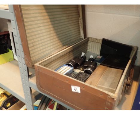 Vintage wood bound suitcase containing mixed items