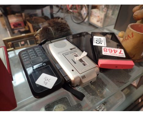 Three mobile telephones and an Olympus microcassette recorder 