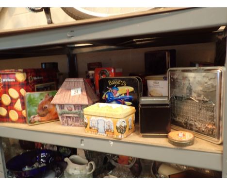 Shelf of mixed collectors tins