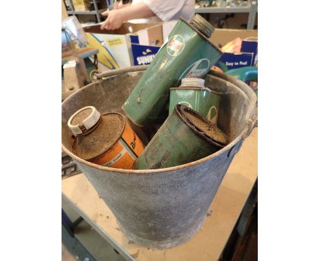 Galvanised bucket containing vintage oil cans including Castrol