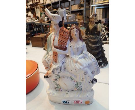 Ceramic flatback of kilted man and woman 