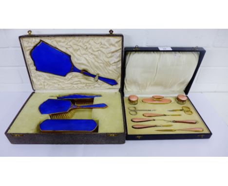 An Art Deco gilt metal and enamel manicure set in original fitted case, together with a blue enamel and brass dressing table 