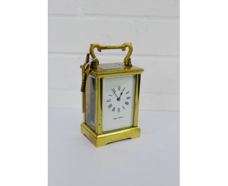 A Mappin & Webb brass cased carriage clock, the white dial with Roman numerals, on a bracket base, 15cm high including handle
