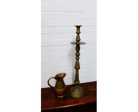 An Indian brass floor standing candlestick holder with all over engraved foliate pattern together with a copper and brass har