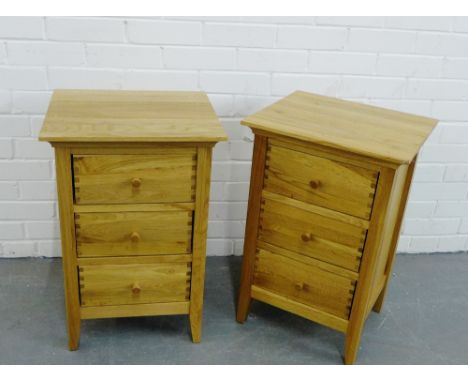 A pair of contemporary light oak three drawer bedside cabinets (2) 65 x 43cm 