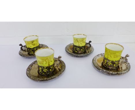 A set of four William Comyns London silver cup holders and saucers, with date letters ranging from 1892 - 1896, complete with