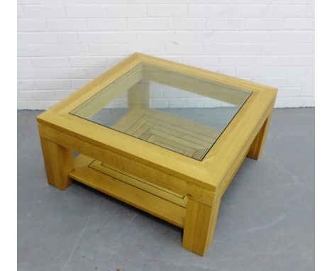 A contemporary light oak coffee table with square glass top,  40 x 86cm