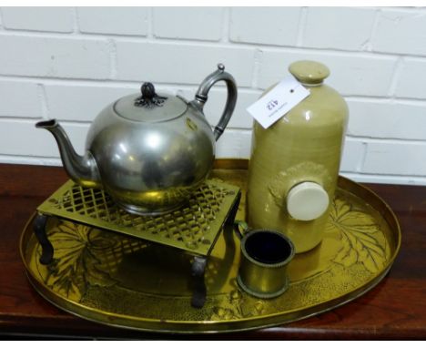 A mixed lot to include an oval brass tray, a brass trivet, pewter teapot and a stoneware hot water bottle etc., (a lot) 