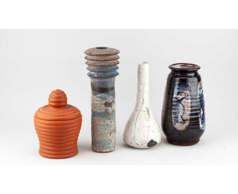 A group of stoneware and earthenware ceramics by different makers comprising a ribbed cylindrical form, teardrop bottle, tape