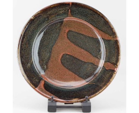 † RAY FINCH (1914-2012) for Winchcombe Pottery; a stoneware charger with kaki pours, impressed WP. mark, diameter 37cm.   Con