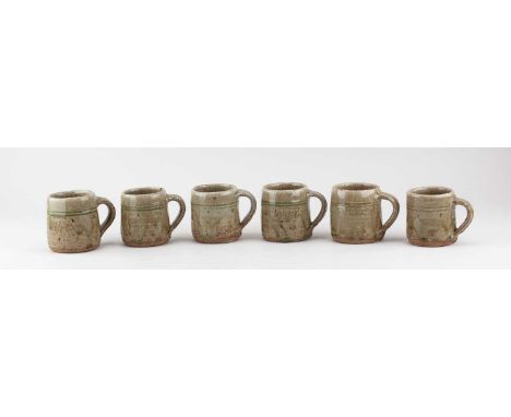 JIM MALONE (born 1946); a set of six stoneware mugs covered in green ash glaze, impressed JM and L (for Lessonhall) marks, he