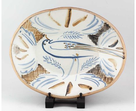 † SETH CARDEW (1934-2016) for Wenford Bridge Pottery; an oval stoneware dish decorated with a bird, diameter 45.5cm.Condition