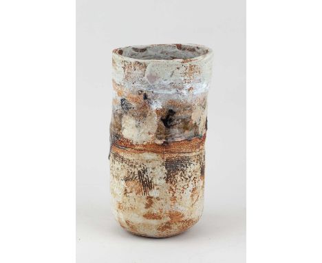 † ROBIN WELCH (1936-2019); a cylindrical stoneware vessel partially covered in mottled pale grey and oatmeal glaze with combe