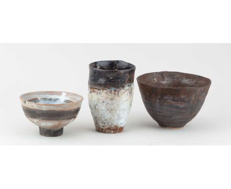 † ROBIN WELCH (1936-2019); a conical stoneware bowl covered in bronze glaze with black enamel pooling to the well, impressed 
