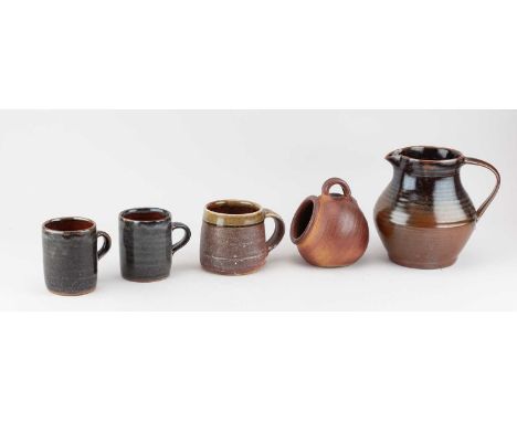 Muchelney Pottery; a small stoneware salt, impressed pottery mark, height 12cm, a trio of mugs, and a Crowan Pottery jug, hei