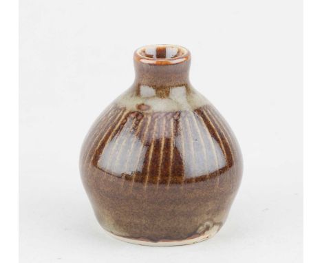 Leach Pottery; a porcelain bud vase covered in iron glaze with sgraffito decoration, impressed pottery mark (partly glaze fil