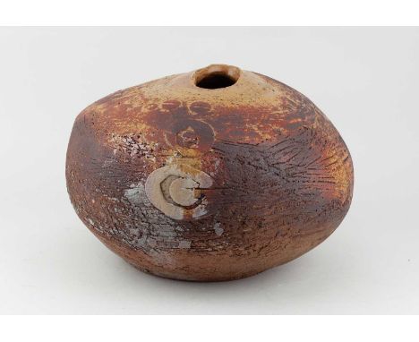 A large stoneware pebble form covered in ochre and rusty glaze with applied and incised decoration, incised mark, height 20.5