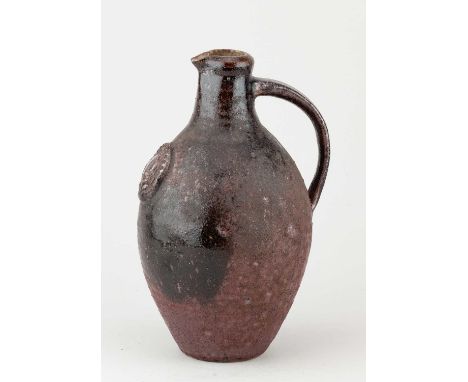 A stoneware flagon with applied medallion covered in iron rich glaze, impressed HS mark, height 25cm.Provenance: Richard Laun