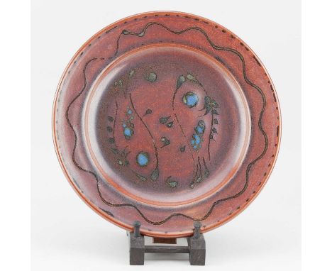 † RAY FINCH (1914-2012) for Winchcombe Pottery; a stoneware charger covered in iron rich glaze decorated with fish, impressed