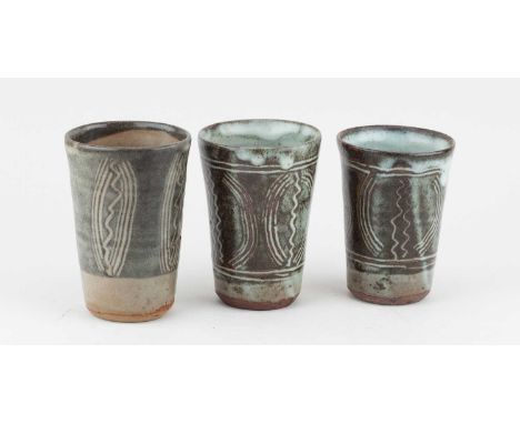 KANDE USHAFA for Abuja Pottery; a trio of stoneware beakers covered in mottled grey and white glaze with combed decoration, i