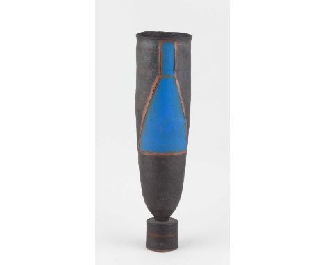 † ROBIN WELCH (1936-2019); a tall stoneware vessel on drum base covered in bronze glaze with funnel shaped panels picked out 