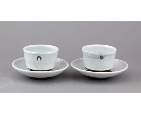 † JACOB VAN DER BEUGEL (born 1978); a pair of stoneware cups and saucers covered in pale blue glaze with manganese decoration