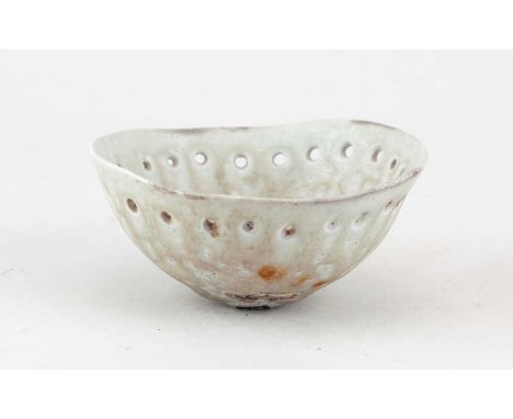 † ALAN WALLWORK (1931-2019); a pierced oval porcelain bowl covered in celadon glaze with broken sherds of pottery to the well