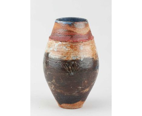 † ROBIN WELCH (1936-2019); an ovoid stoneware vessel partially covered in bronze glaze with red and blue top, height 24cm.Pro