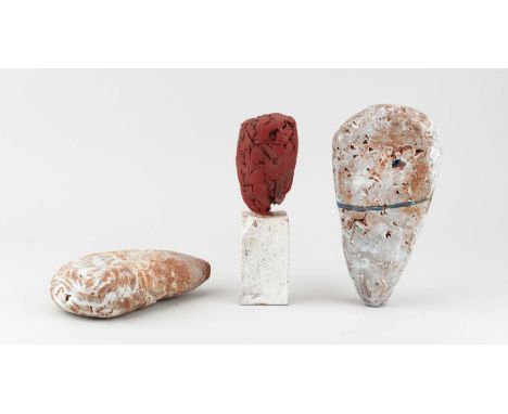 † ROBIN WELCH (1936-2019); a stoneware sculptural form on a rectangular base covered in red glaze, height 18.5cm, and a pair 