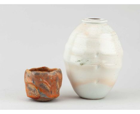 † PASCAL GEOFFROY (born 1951); a small stoneware yunomi covered in shino glaze, impressed mark, height 7.5cm, and a ribbed ov