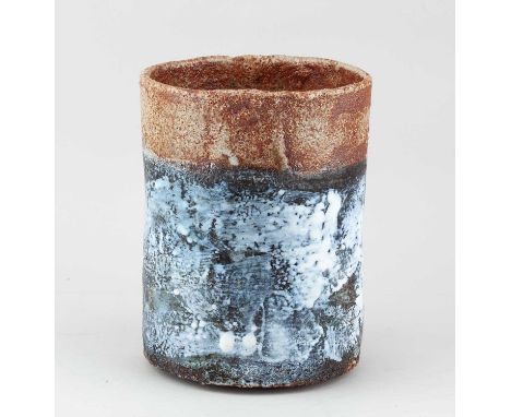 † ROBIN WELCH (1936-2019); a cylindrical stoneware vessel partially covered in mottled black and white glaze with oatmeal and