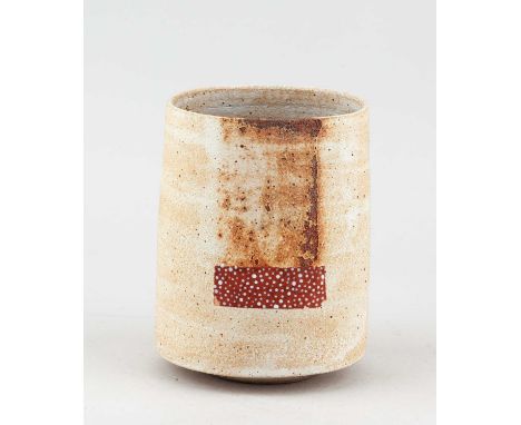 † ROBIN WELCH (1936-2019); a cylindrical stoneware vessel covered in sandy yellow glaze and iron staining with rectangular pa
