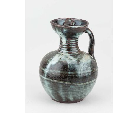 Attributed to LADI KWALI (1925-1984) for Abuja Pottery; a stoneware flagon or water jug with screw top covered in mottled iro