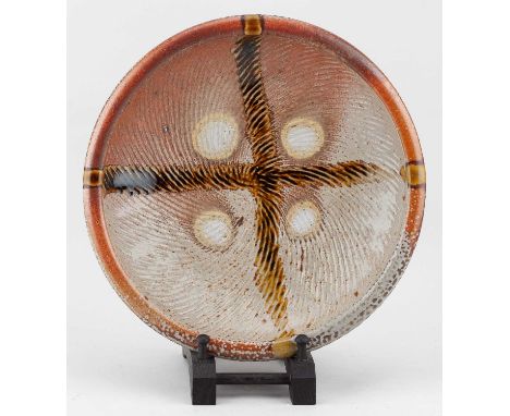 † PHIL ROGERS (1951-2020); a fluted salt glazed dish with tenmoku pours, impressed PR mark, diameter 28.5cm.Provenance: Purch