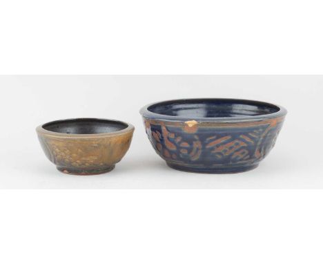 † Attributed to BERNARD LEACH (1887-1979) for Leach Pottery; a stoneware bowl covered in dark blue glaze with wax resist deco