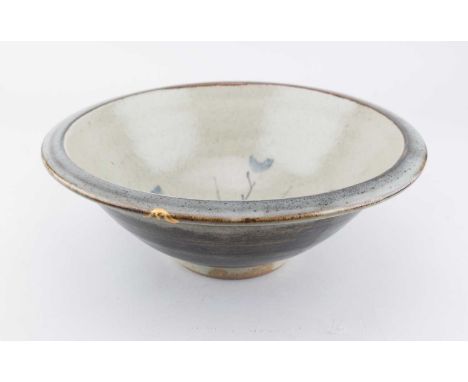 † Attributed to BERNARD LEACH (1887-1979) for Leach Pottery; a large stoneware bowl covered in blue/grey glaze washed with ir