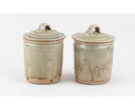 JIM MALONE (born 1946); a pair of stoneware jars and covers covered in green ash glaze with impressed decoration, impressed J