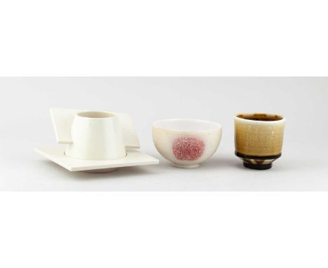 † DEREK NORTHFIELD; an Art Deco style porcelain cup and saucer, inscribed signature, cup height 6cm, saucer 14 x 14cm, a porc