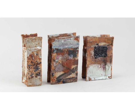 † ROBIN WELCH (1936-2019); a trio of rectangular stoneware slab forms with winged tops covered in polychrome glaze, impressed