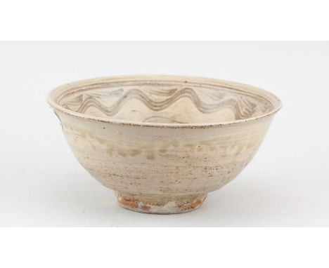 † JIM MALONE (born 1946); a stoneware bowl covered in green ash glaze with incised fish decoration, impressed JM and A (for A