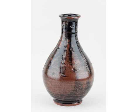 JIM MALONE (born 1946); a stoneware Korean bottle covered in tenmoku breaking to kaki glaze with combed decoration, impressed