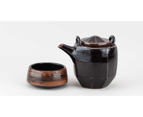 † WILLIAM MARSHALL (1923-2007); a faceted stoneware teapot (missing its cane handle) covered in tenmoku breaking to kaki glaz